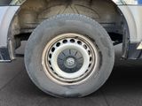 a white truck with a flat tire parked in a parking lot