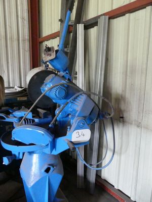 a woman standing next to a blue machine in a building