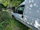 a white van that is parked in the grass