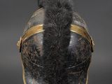 an old helmet with a furry tail on a black base