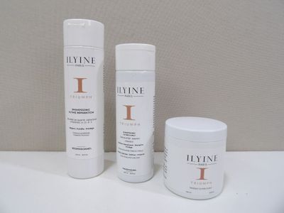 two bottles of hair products sitting on a white surface