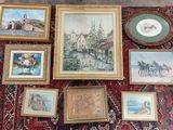 many framed pictures on a rug on the floor