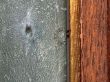 a close up of a wooden door with a rusted surface