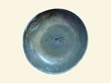 a metal bowl that is sitting on a table