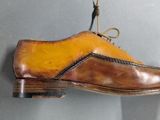 a shoe hanging on the wall with a rope