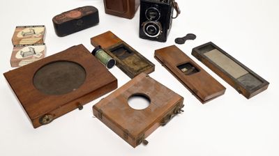 a lot of old cameras and other items on the table