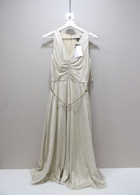 a white dress hanging on a hanger next to a white wall