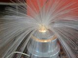 a picture of a red and white fire hydrant with water coming out of it