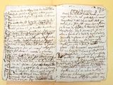 an old book with writing on it sitting on top of a table