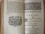 an open book with a picture of a coat of arms on it