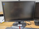 two computer monitors sitting on a desk with a keyboard and mouse