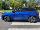 the blue suv is parked on the side of the road