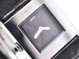 a close up of a watch on a black leather strap