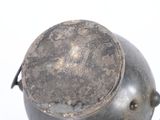 a metal pot with a handle on a white surface