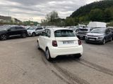 a white car parked in a parking lot next to other cars
