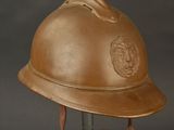 an old helmet on a metal stand with a black background