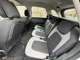the interior of a car with four rows of seats in it
