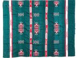 a green rug with red and white designs on it