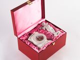a small box with a tea set inside of it