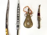 three different types of knives on a white surface