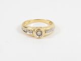 a yellow gold ring with a white diamond and two small diamonds