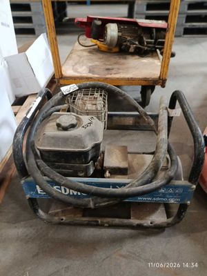 a small machine that is sitting on a pallet in a warehouse