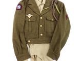 an army uniform worn by a soldier on display on a white background