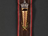 a close up of a medal with a crown on it
