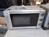 two microwaves that are sitting on a table
