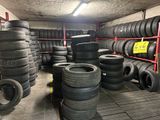 tires are stacked on a rack in a warehouse with a lot of them