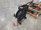 a man that is working on a machine in a warehouse