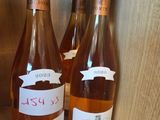 three bottles of wine sitting on a shelf next to each other