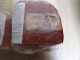 two packages of meat sitting on a table