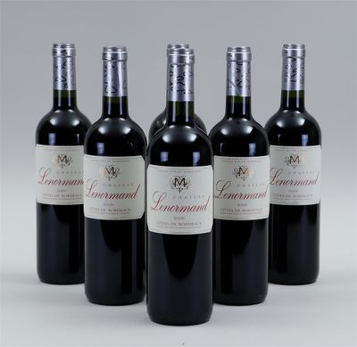 four bottles of wine are lined up in a row