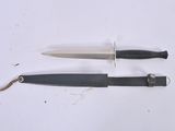 two knives that are laying side by side on a table