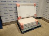 a stack of boxes on a pallet in front of a wall