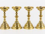three brass candlesticks on a white background with a white background