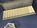a box with a lot of cigarettes in it on a blue surface