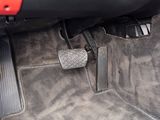 a close up of a car ' s floor with pedals and pedal covers