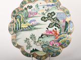 a plate that has a picture of a woman sitting on a bench