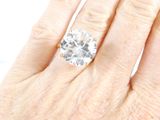an image of a woman ' s hand with a diamond ring on it