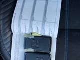 two remote controls sitting on the seat of a car