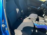 the interior of a small blue car with the door open