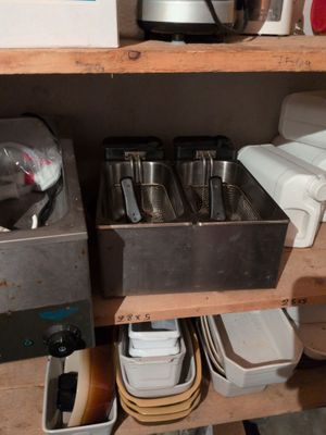 a shelf that has a bunch of pots and pans on it