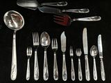 a lot of silver spoons and forks on the table