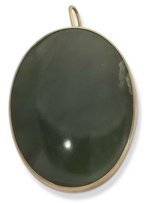 a close up of a green round object on a white surface