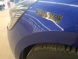 a close up of a blue car with a sticker on it