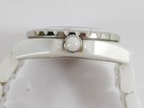 a close up of a watch on a white surface