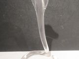 a glass sculpture of a flower on a stand