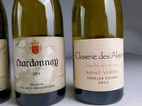 three bottles of wine are lined up on a table